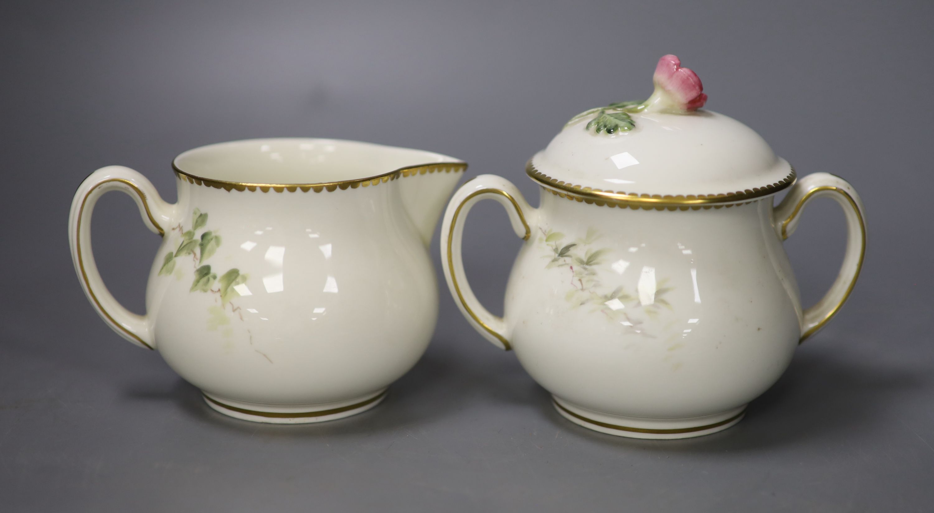 A Royal Worcester sugar bowl painted with a Redstart and cover and a cream jug painted with a Wren by E. Townsend, signed black mark